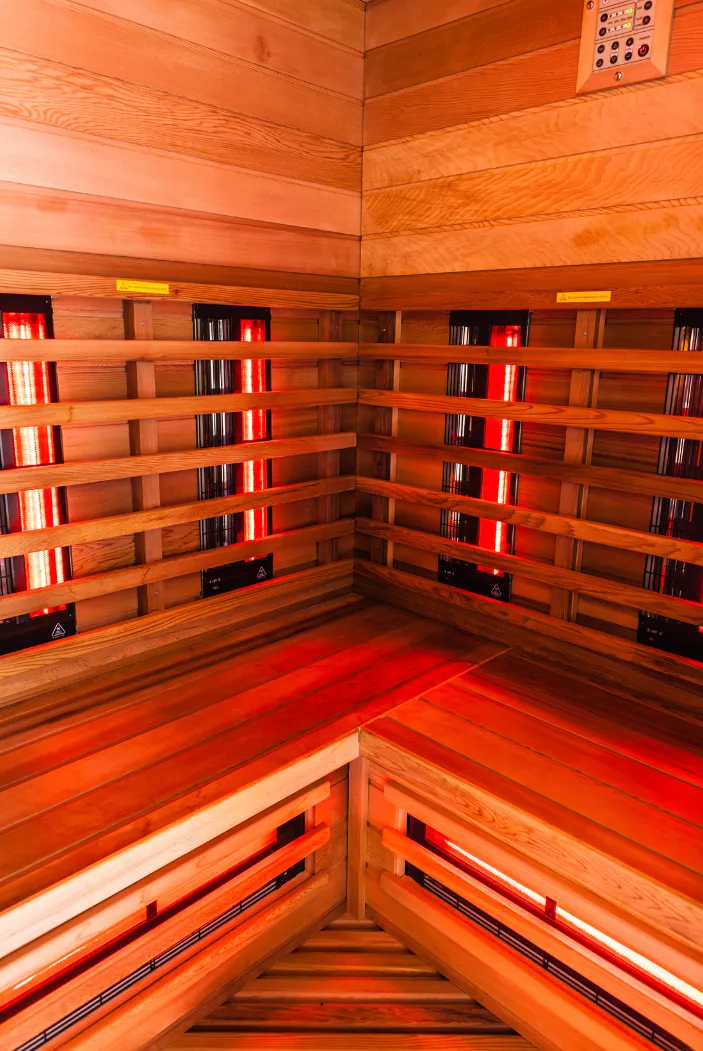 An infrared sauna uses infrared lamps to increase heat and warm the body directly.